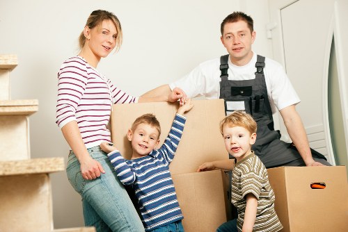 Professional movers carrying boxes during a flat removal